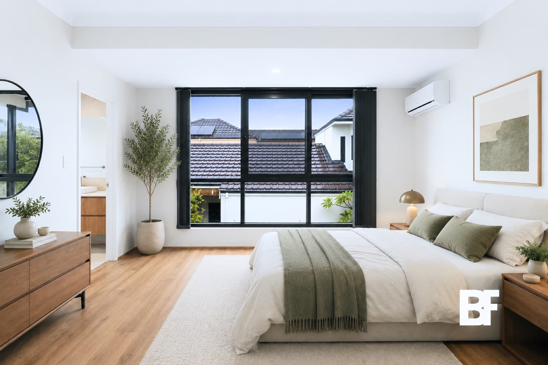 Bright primary bedroom with neutral styling photographed by BASEFORM