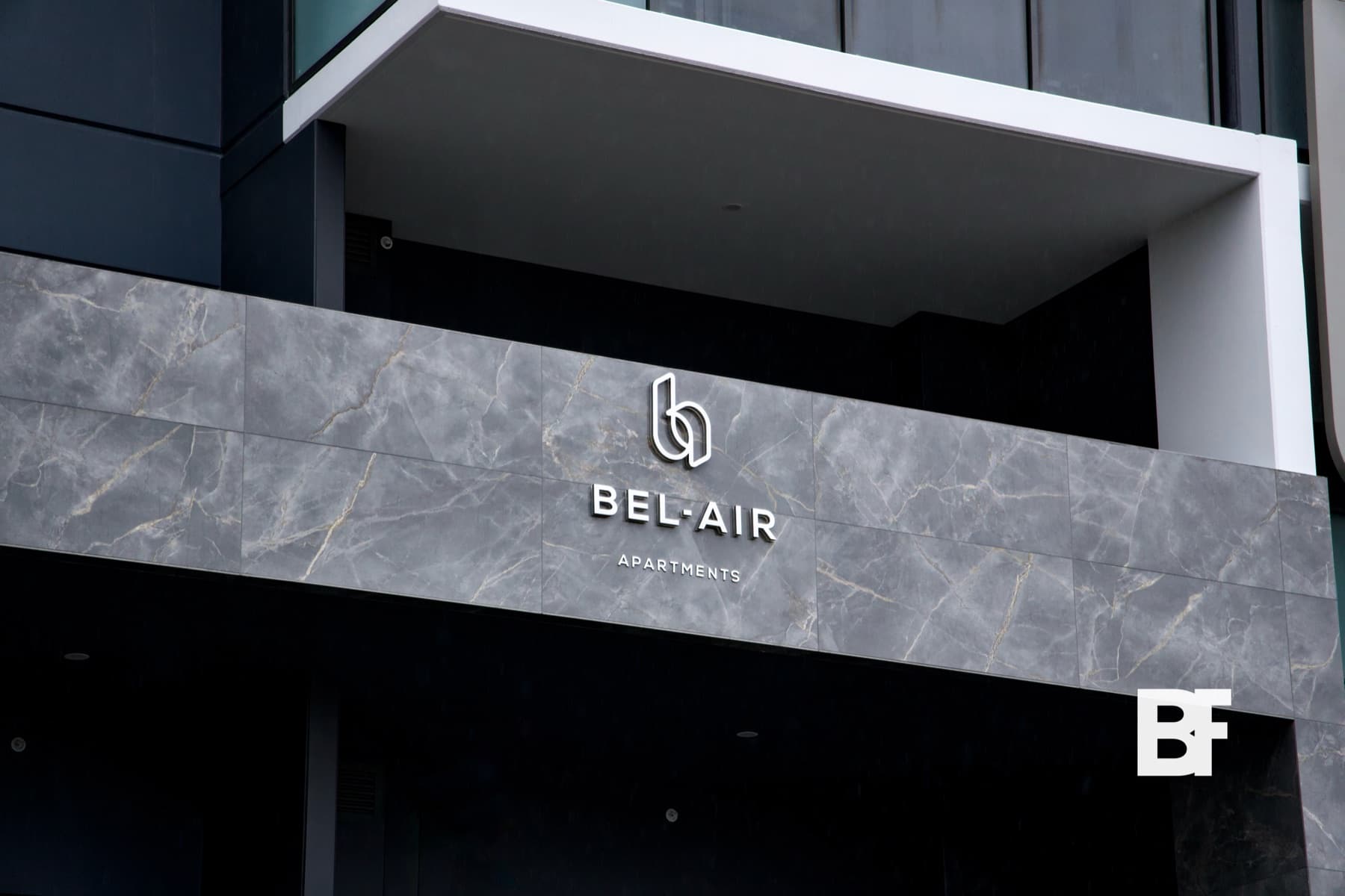 Bel-Air Apartments exterior signage and stone facade photographed by BASEFORM