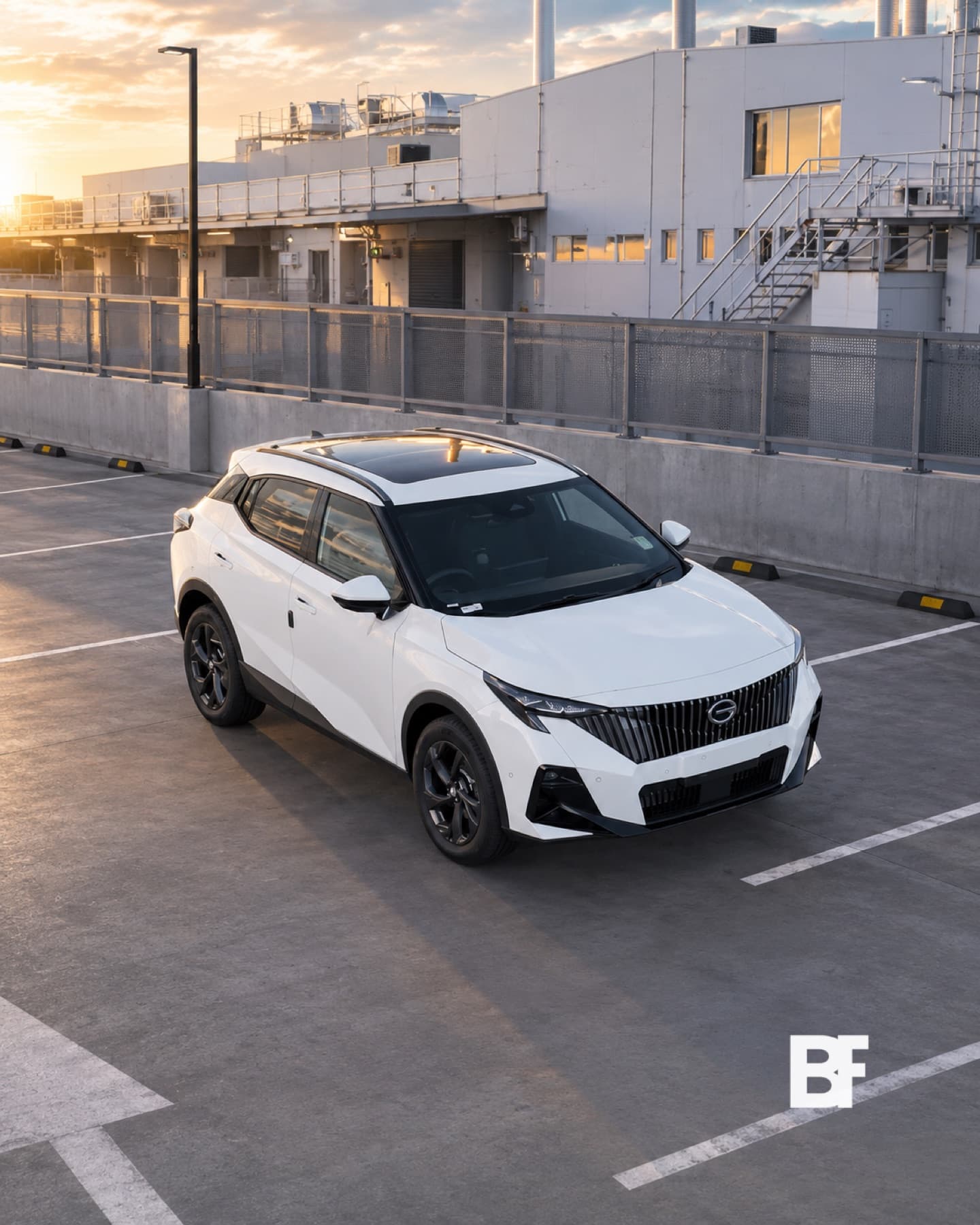 White vehicle photographed in a modern urban campaign setting